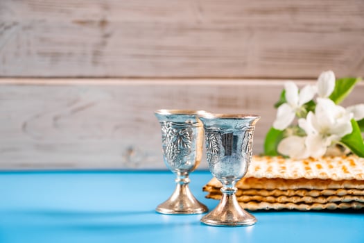 Happy passover. Metal goblet and matzah on blue background photo