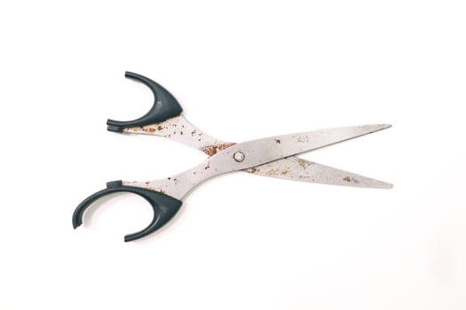 Rusty scissors isolated on a clean white surface ready for creative projects photo