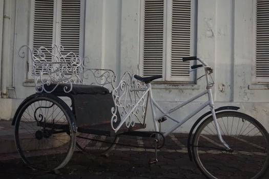 Ornate trishaw parked colonial building street photo