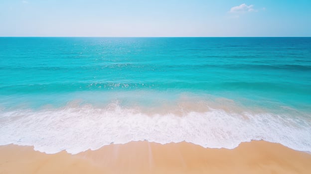 Calm turquoise beach with gentle waves lapping at shore under bright sunlight photo