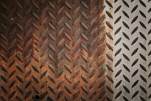Rusty checkered steel plate showing signs of age and wear photo