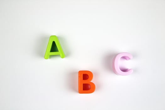 On a white background, bright and colorful letters of the English alphabet in a chaotic order. concept of teaching preschool children photo