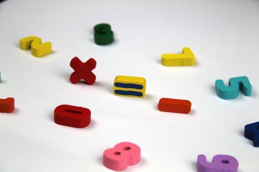 On a white background there are mathematical signs, in a crumpled shape of numbers. The concept of education and school. photo