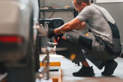 Changing the tire. Man is ,works in the automobile repairing salon photo