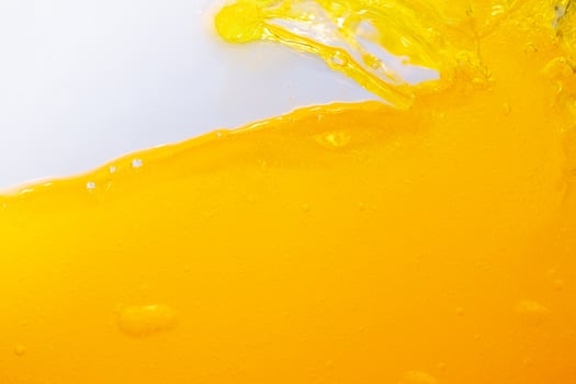 Close up bright orange juice splash texture for health and nature waves, Beautiful waves curve and little bubbles smooth for garphic design and backgr photo