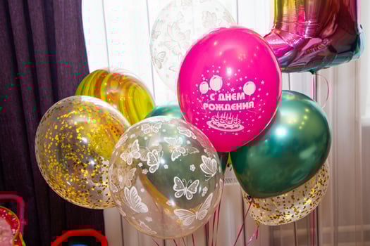A bunch of balloons with a birthday cake on them photo