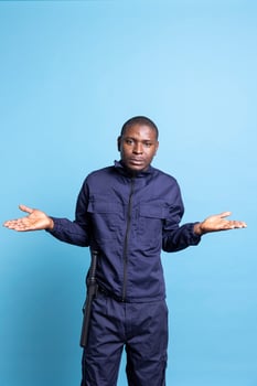 African american uncertain bodyguard shows i dont know gesture in studio, shrugging and being confused or doubtful about something. Clueless unsure security agent in front of camera. photo