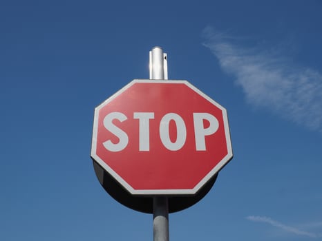 stop sign over a blue sky photo