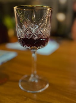 Small glass with a drink - whiskey, cognac, rum, port or even juce.Concept of holiday, romance or luxury photo