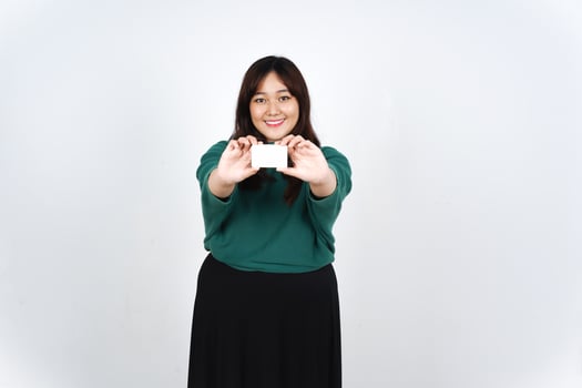 Asian woman holding up a white card photo