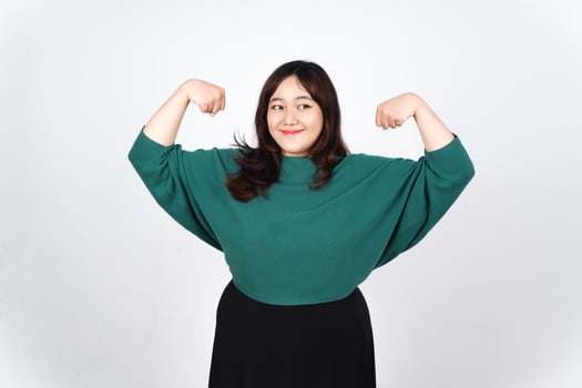 A woman in a green shirt flexing her biceps photo