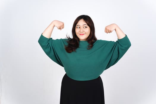A woman in a green shirt flexing her arms photo