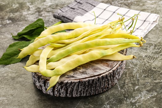 A bunch of beans on a wooden log photo