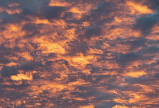 A stunning sunset paints the sky with fiery oranges and deep, contrasting clouds. photo