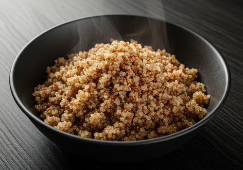 Steaming bowl of cooked quinoa, a healthy and delicious meal option, ready to eat. photo
