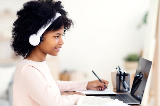 Happy Black Teen Girl At Laptop Doing Homework Online Sitting At Table At Home. Distant Education, Remote Learning Concept photo