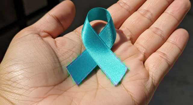 world day ovarian world, Teal Ribbon in Palm of Hand photo