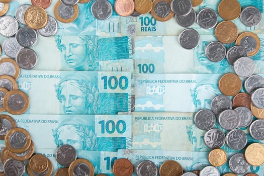 Brazilian real banknotes and coins spread out as financial and currency concept photo