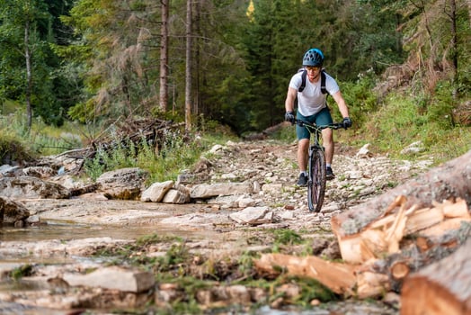 Professional mountain bike cyclist riding a trail extreme sport outdoor active lifestyle. photo