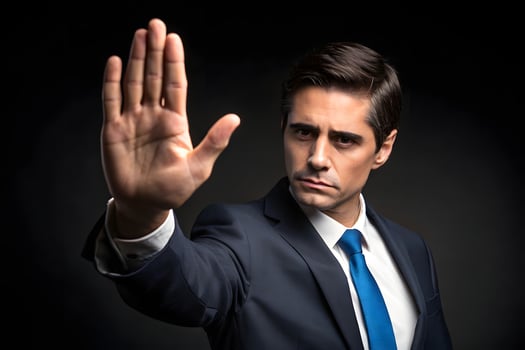 A man in a suit is holding up his hand photo
