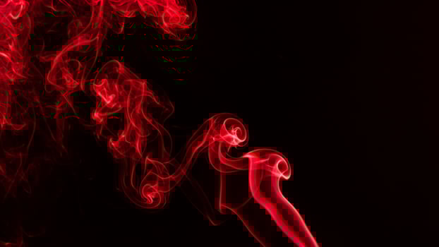 Red smoke wave effect on deep black background photo