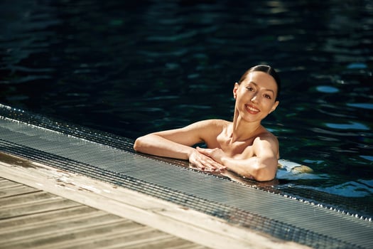 Positive woman, in white, underwear is in the pool photo