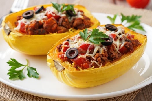 Spaghetti squash boats filled with ground meat and vegetables ready to serve photo