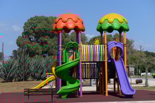 Colorful playground structures invite joyful play under a bright blue sky in a sunny park setting photo