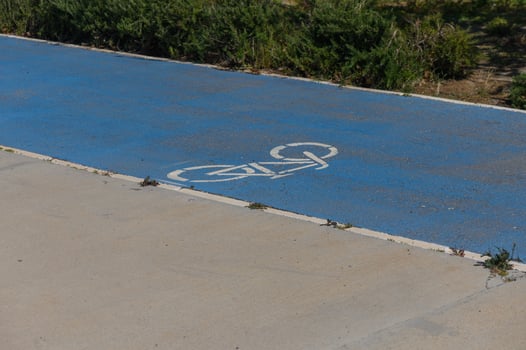 Bright blue bicycle lane inviting cyclists to explore nature on a sunny day in a serene park photo