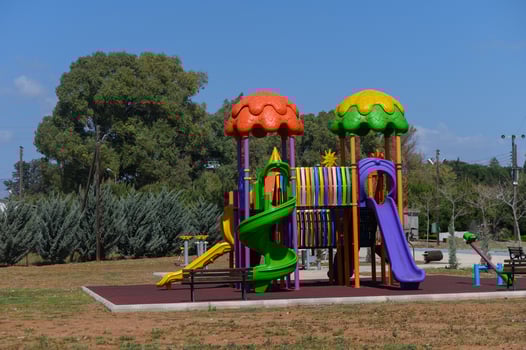 Colorful playground structure invites joyful play under a clear blue sky in a serene park setting photo