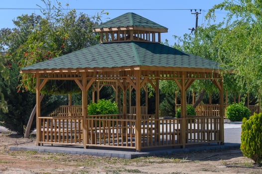 Elegant wooden gazebo invites relaxation amidst lush greenery in a tranquil garden setting photo