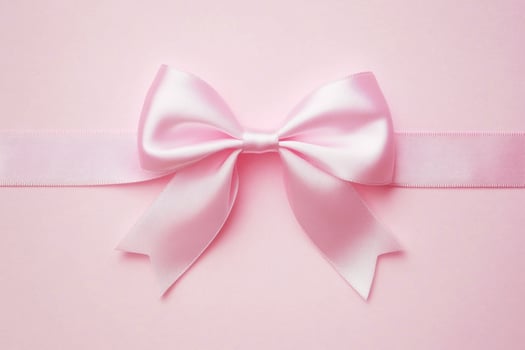 Elegant pink ribbon bow on soft pastel background photo
