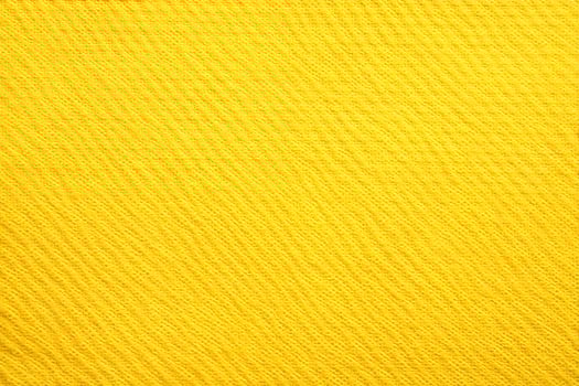 Vibrant yellow textile fabric showcasing intricate woven patterns in natural light photo