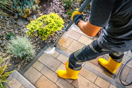 Cleaning Outdoor Steps With a Pressure Washer in Bright Yellow Boots photo