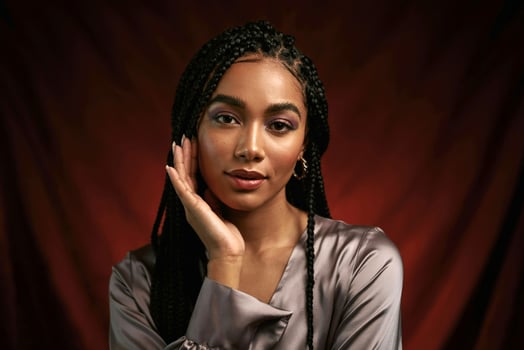 A woman with long braids posing for a portrait photo