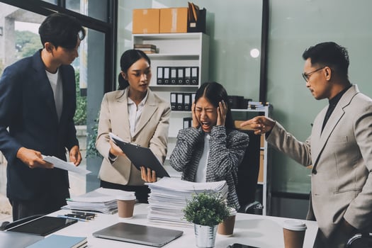 Three business people in an office with paperwork photo