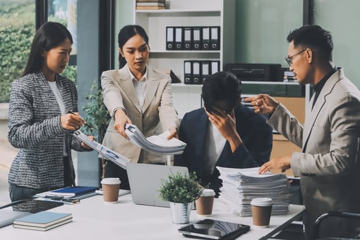 A group of business people working at a desk photo