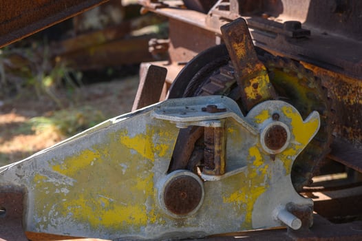 Colorful machinery detail captures the essence of abandoned industrial equipment in a sunlit setting photo