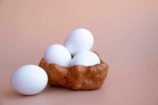 Minimalist Still Life White Eggs in Natural Wooden Bowl Rustic Style Delicate Beige background. Natural Tones Perfect for Kitchen Decor Culinary Themes Diet Proteins Breakfast articles Easter themes photo