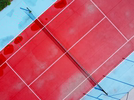 empty tennis court from bird's eye view aerial drone view of red and blue tennis court photo