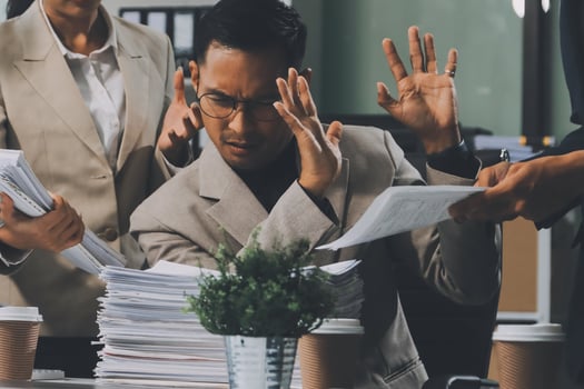 A man in a suit is holding a stack of papers photo