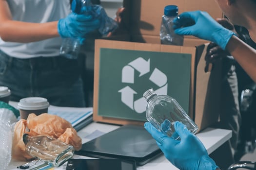 People in blue gloves and gloves are sorting recyclable items photo