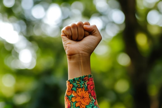 Raised fist of a woman, outdoor. photo