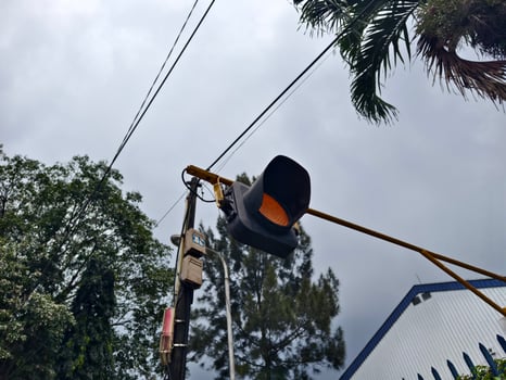Traffic Light with Yellow Signal on an Urban Road Intersection photo