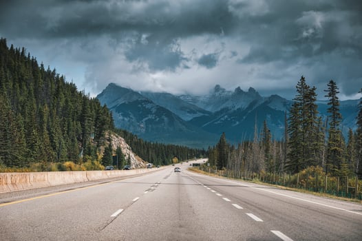 Scenic road on highway and moody sky in Canadian Rockies at Banff national park photo