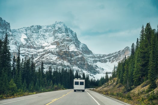 Road trip with motorhome driving in rocky mountains in summer at Banff national park, Canada photo