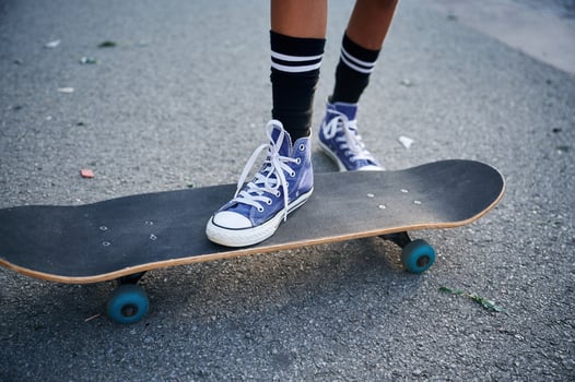 Close up, view of skateboard riding by a young girl photo