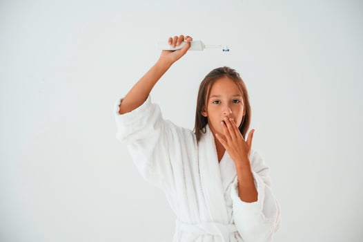 Toothbrush, in, hand. .Conception of beauty and self care. Young girl is in the studio photo