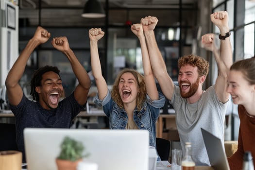 Five people celebrating in an office photo
