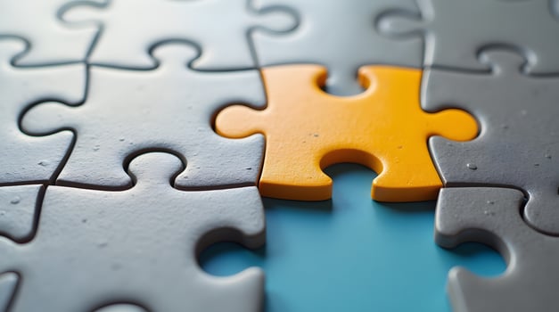 Jigsaw Puzzle Pieces with One Yellow Piece on Blue Background photo